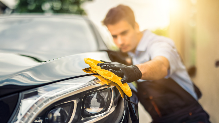 Worker polishing car